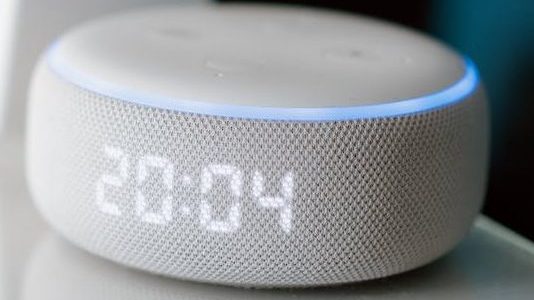 white smart speaker on the table